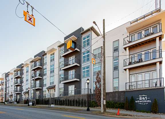 A street view of apartment buildings with a sign that reads "841 Memorial.".