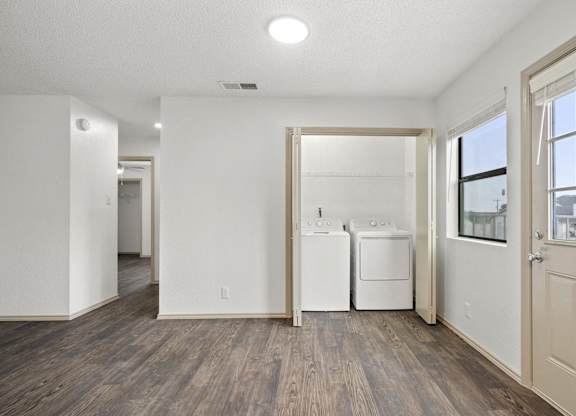 A white room with a washer and dryer in it.