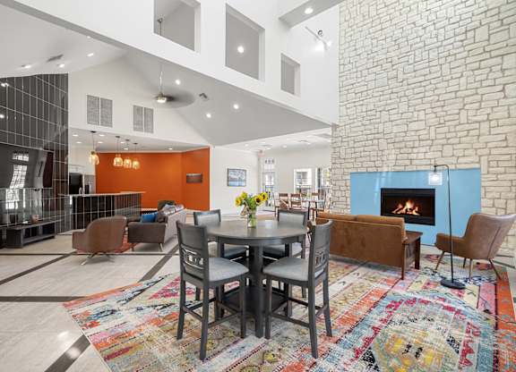 A modern living room with a brick wall and a fireplace.