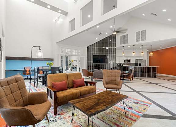 A living room with a brown chair and a brown couch.