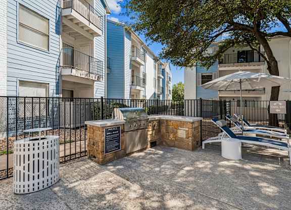 A sunny day at the outdoor seating area of a residential complex.