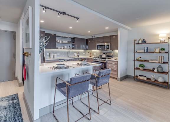 A modern kitchen with a dining table and chairs.