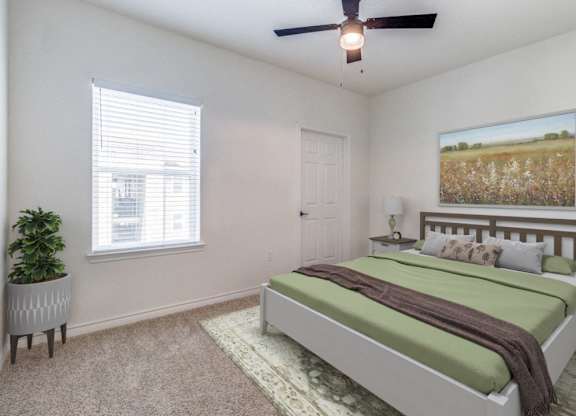 a bedroom with a bed and a ceiling fan