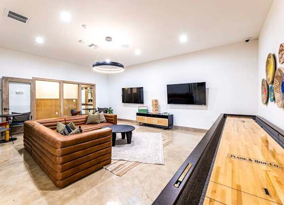 A room with a pool table and a couch.