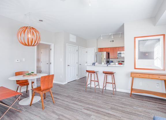 A kitchen with a table and chairs.
