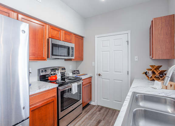 A kitchen with wooden cabinets and a white refrigerator.