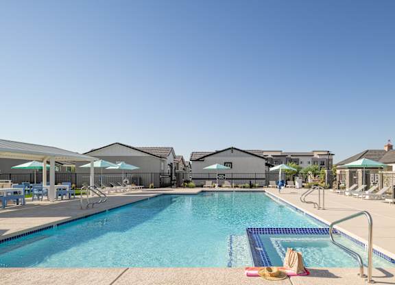 A swimming pool with a hat and a towel on the side.