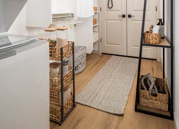 A white oven sits next to a white fridge in a small kitchen.