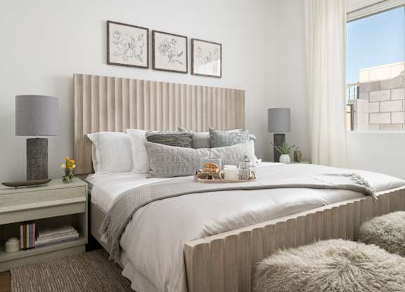 A bedroom with a large bed and a window.