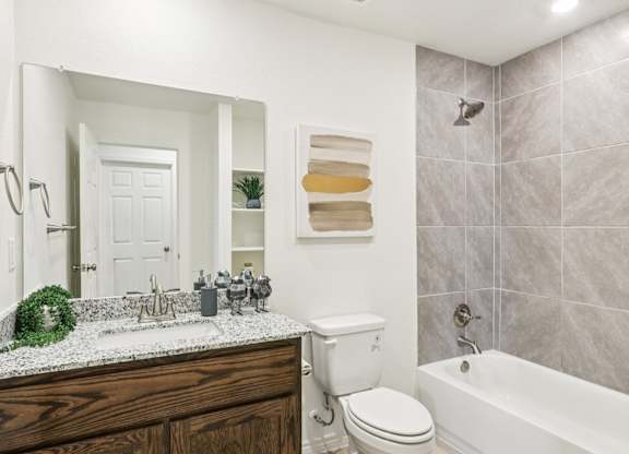 A bathroom with a white toilet and a white sink.