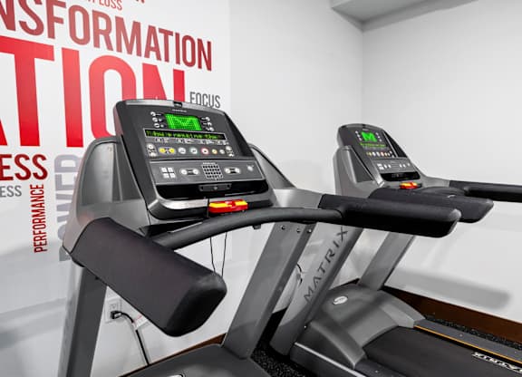 a close up of two treadmills in a gym