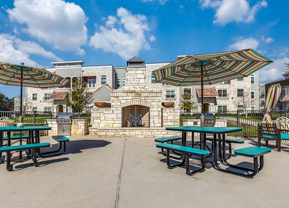 A sunny day at the outdoor picnic area with tables and umbrellas.