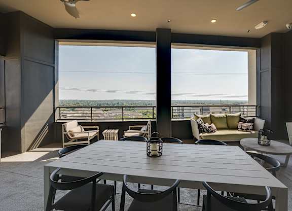 A modern dining room with a table set for six.