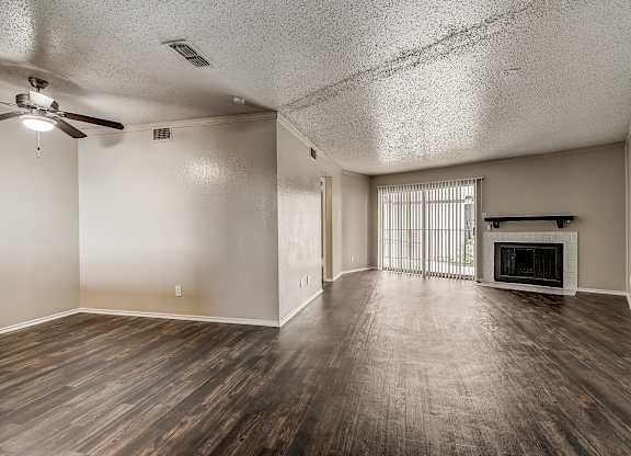 a living room with hardwood floors and a fireplace