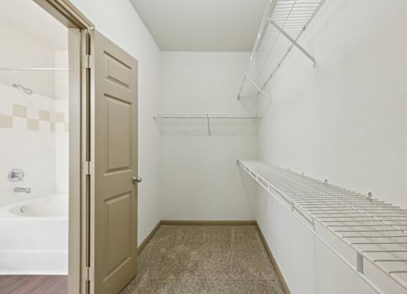 A white laundry room with a white washer and dryer.