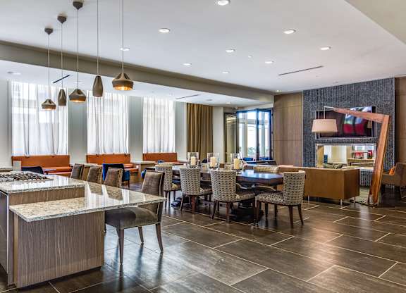 A modern dining room with a long table and chairs.