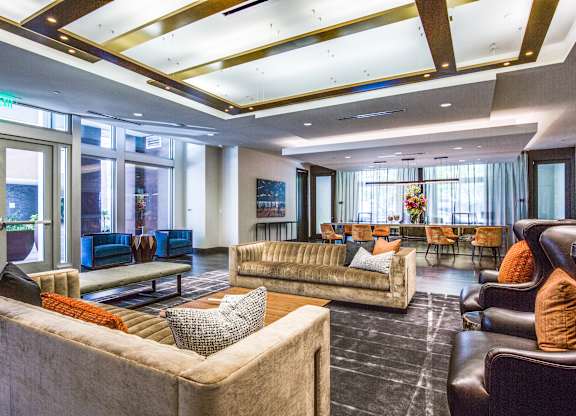 A spacious living room with a couch, chairs, and a coffee table.