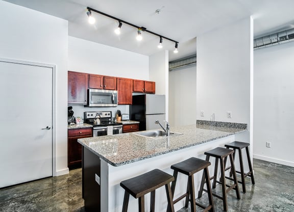 kitchen with an island with granite countertops