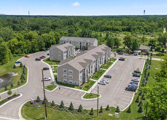 A large building complex with a parking lot in front.