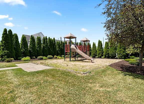 a playground with a slide in a park