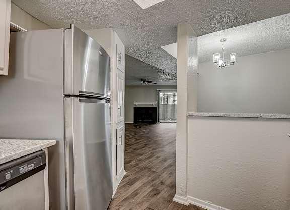 a kitchen and living room in an apartment