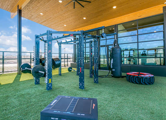 A gym with a green floor and a wooden ceiling.