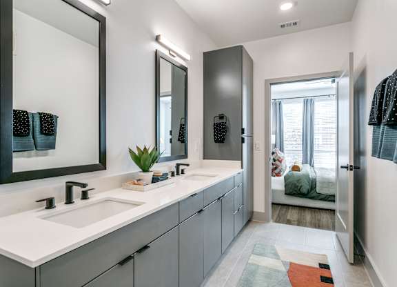 A bathroom with a white sink and a mirror above it.