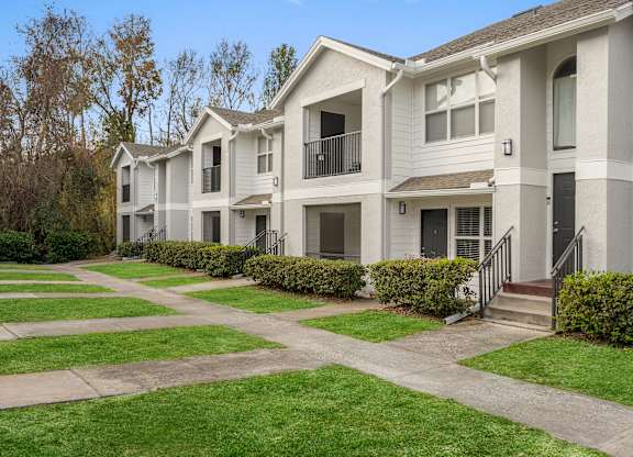 Apartment complex with a green lawn in front.