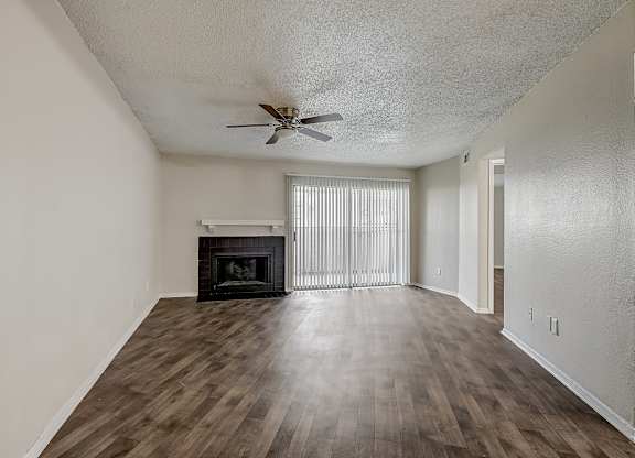 a living room with hardwood floors and a fireplace