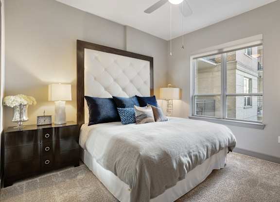 a bedroom with a large bed and a window