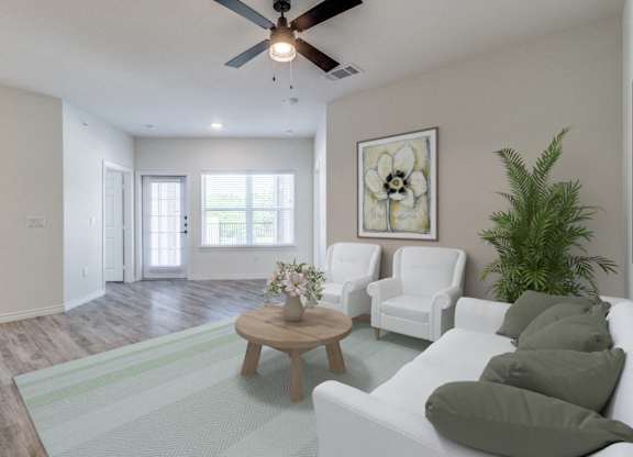 an open living room with white furniture and a ceiling fan