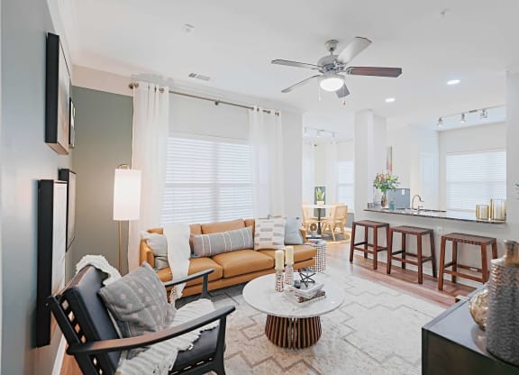 a living room with a couch and a ceiling fan