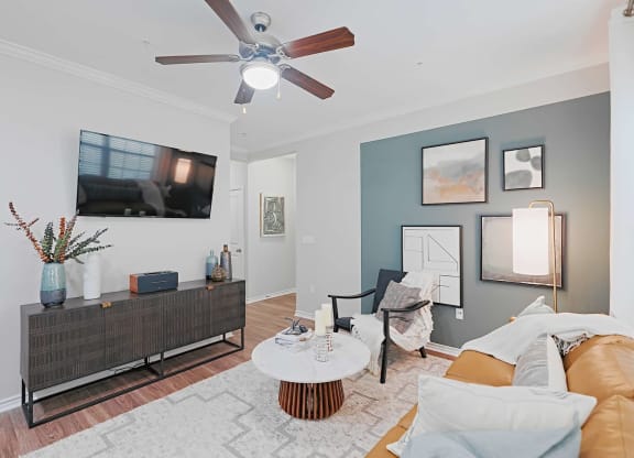 a living room with a couch and a ceiling fan