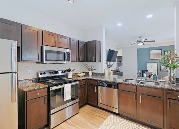 a kitchen with stainless steel appliances and wooden cabinets