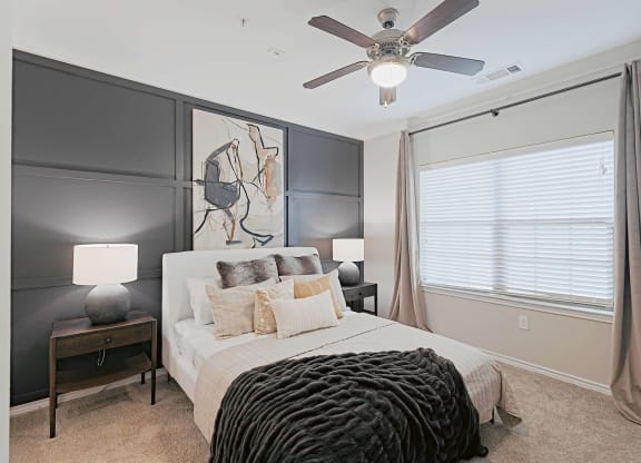 a bedroom with a bed and a ceiling fan