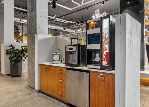 A modern kitchen with wooden cabinets and a stainless steel refrigerator.
