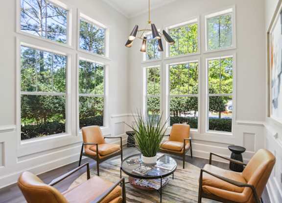 A sunny room with a table and chairs.