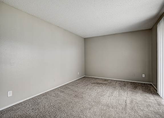 a bedroom with gray walls and a carpeted floor