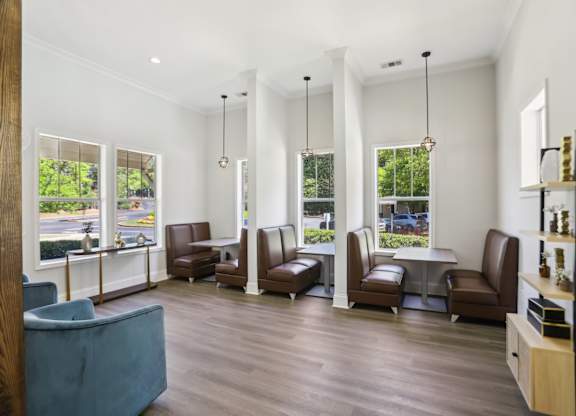 A waiting room with brown leather chairs and a blue sofa.