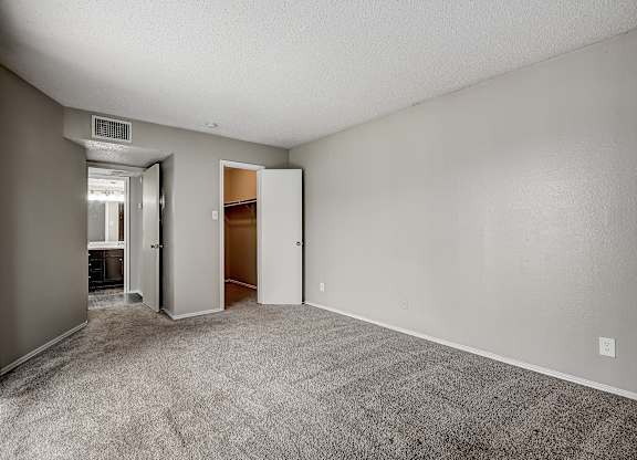 a bedroom with gray carpet and white walls