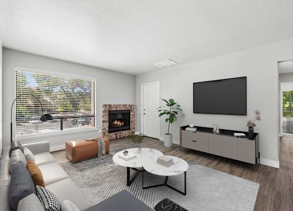 A modern living room with a fireplace and a flat screen TV.