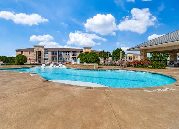 a swimming pool with a building in the background