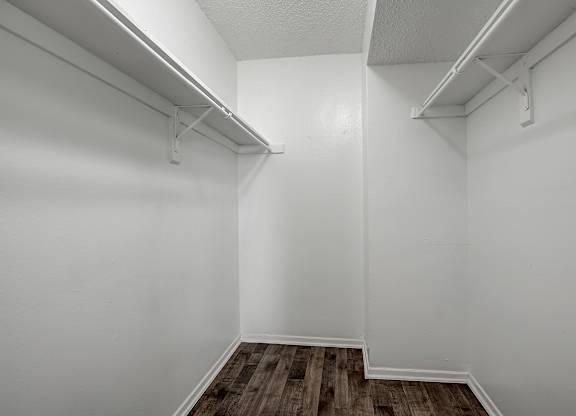 an empty room with white walls and a wooden floor