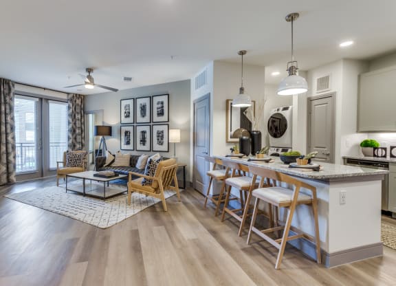 a living room with a kitchen and a dining table