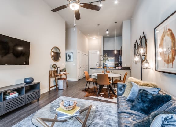 a living room with a couch and a table and a ceiling fan