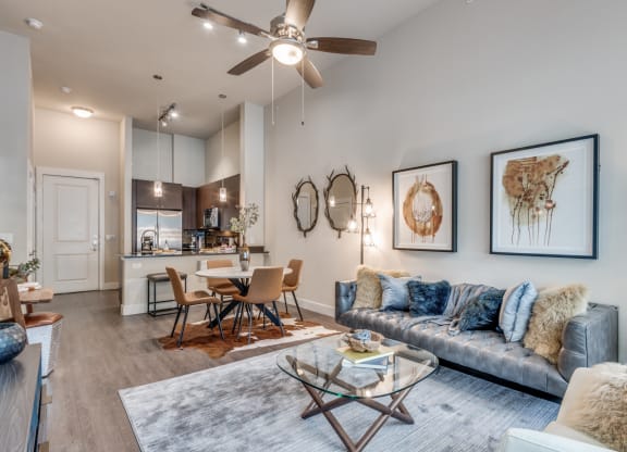 a living room with couches and a glass coffee table