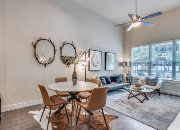 an open living room with a dining room table and a couch