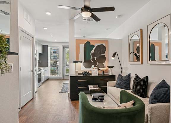 A modern living room with a green sofa and a black coffee table.