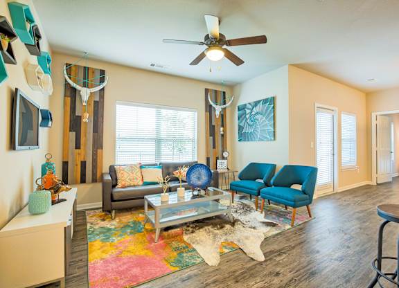 A living room with a grey couch and a blue chair.