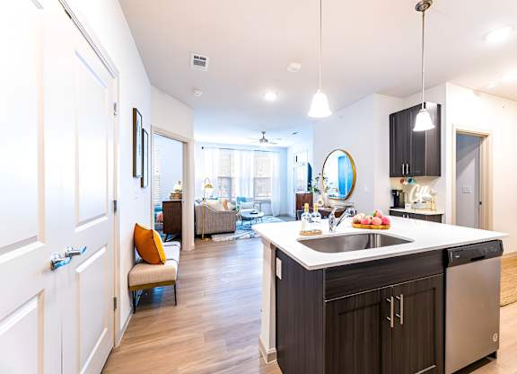 A modern kitchen with a large island and stainless steel appliances.